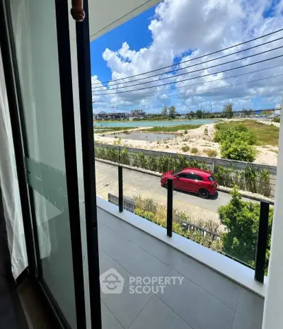 Spacious balcony with stunning view of open landscape and blue skies, perfect for relaxation.