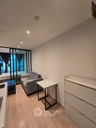Modern living room with sleek furniture and large windows in a stylish apartment.