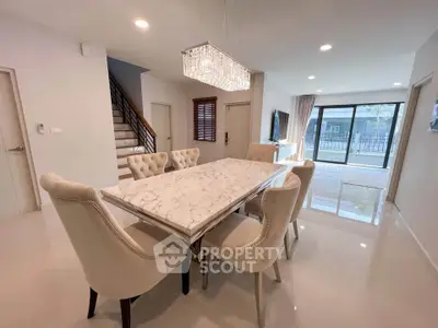 Elegant dining area with marble table and plush chairs in modern home