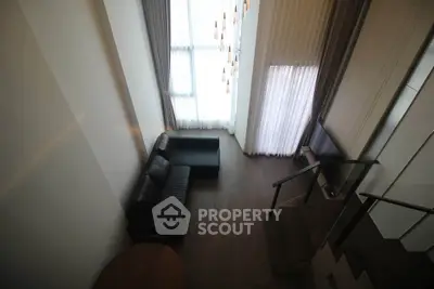 Spacious modern living room with high ceilings and elegant lighting