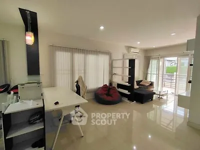 Spacious modern living room with sleek furniture and large windows for natural light.