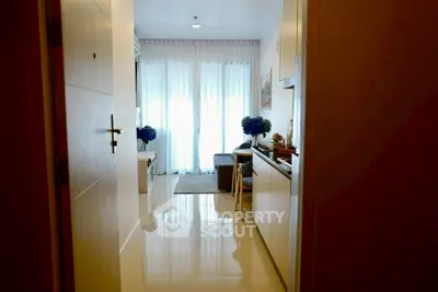 Stylish apartment entrance with glossy floors and cozy living area.
