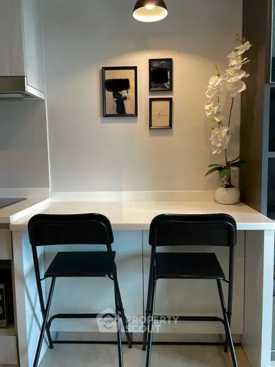 Modern kitchen nook with sleek bar stools and elegant decor