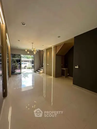 Spacious modern living room with elegant lighting and garden view