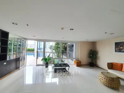 Spacious living room with pool view and modern decor in luxury apartment