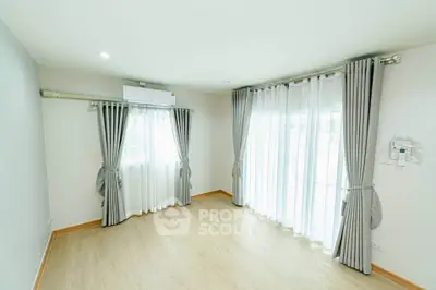 Bright and airy empty room with large windows and elegant curtains, perfect for customization.