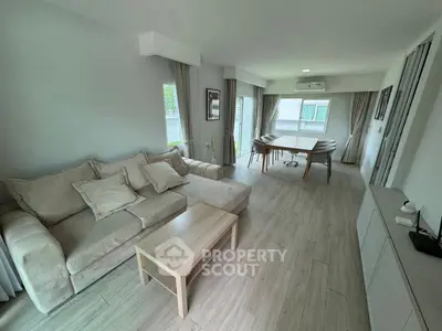 Spacious modern living room with elegant decor and ample natural light.
