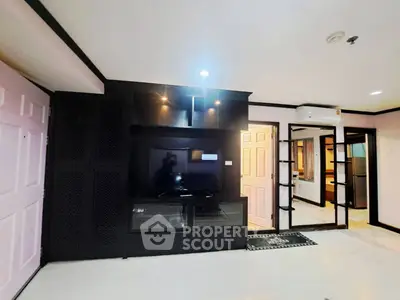 Modern living room with sleek black entertainment center and mirrored accents