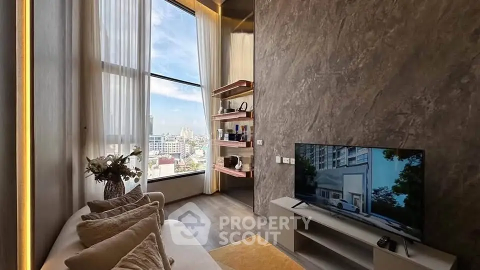 Luxurious living room with high ceilings and stunning city view, featuring modern decor and large windows.