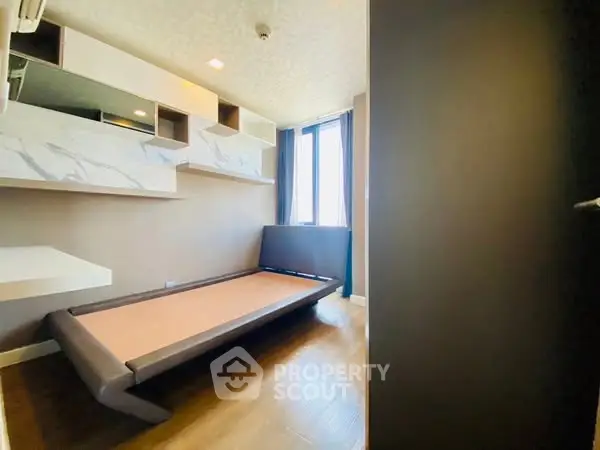 Modern bedroom with sleek design and large window for natural light