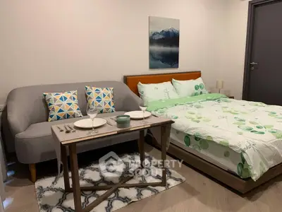 Cozy bedroom with stylish decor and compact dining setup, perfect for modern living.
