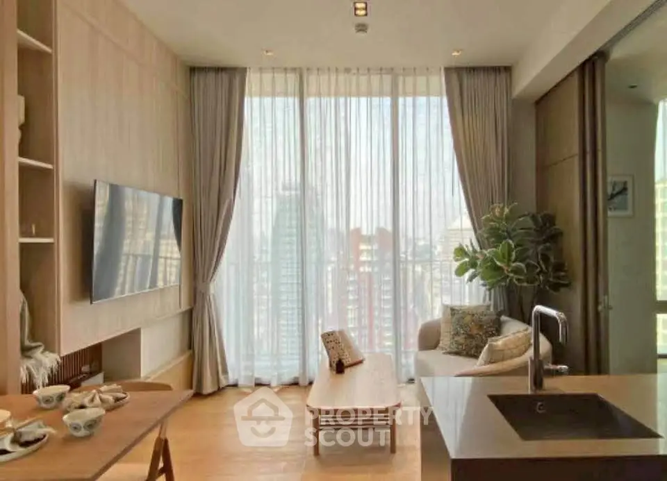 Modern living room with large windows and stylish decor in a high-rise apartment.