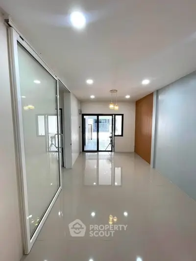 Spacious modern living room with sleek design and ample natural light.