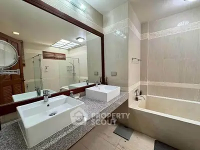 Luxurious bathroom with modern fixtures and elegant design, featuring a spacious bathtub and stylish vanity.