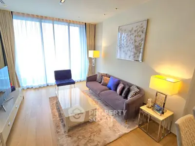 Elegant living room with modern decor, large windows, and stylish furniture in a bright apartment.