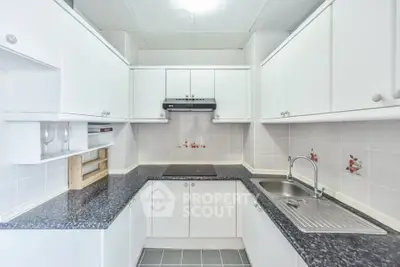 Modern kitchen with sleek white cabinets and stylish countertops