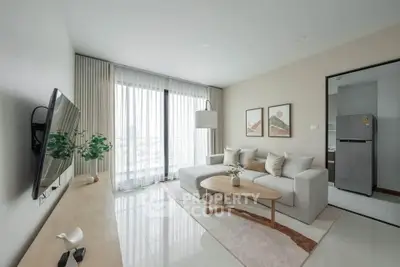 Modern living room with sleek design, large window, and stylish furniture in a contemporary apartment.