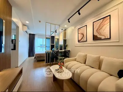 Modern open-plan living room with elegant decor and cozy seating area