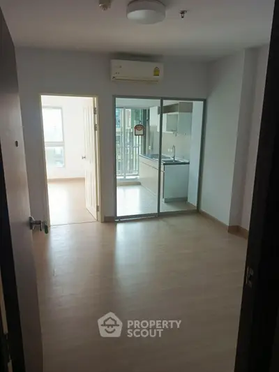 Spacious apartment with open layout and modern kitchen, featuring large windows for natural light.