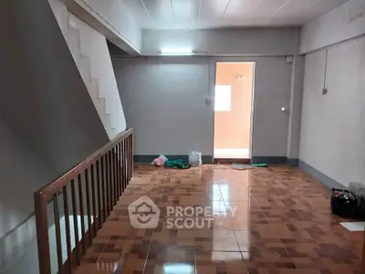 Spacious interior with tiled flooring and staircase, ideal for creative renovation.