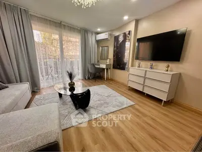 Modern living room with stylish decor, large TV, and elegant furniture, featuring a cozy ambiance and natural light.