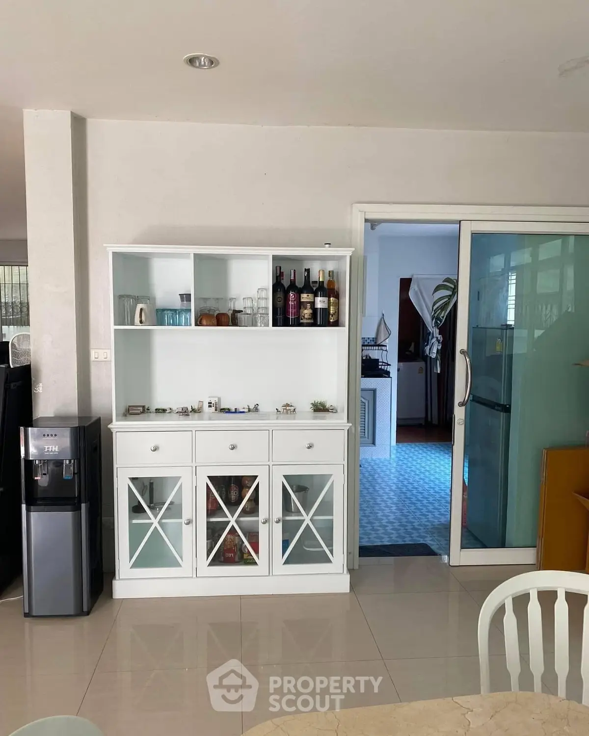 Spacious dining area with elegant white cabinet and sliding glass door