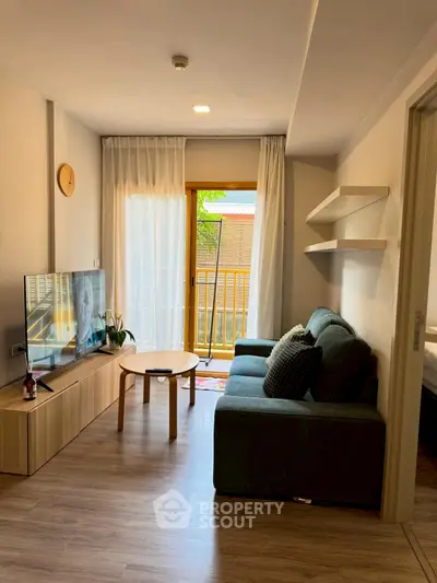 Cozy living room with modern decor and balcony access