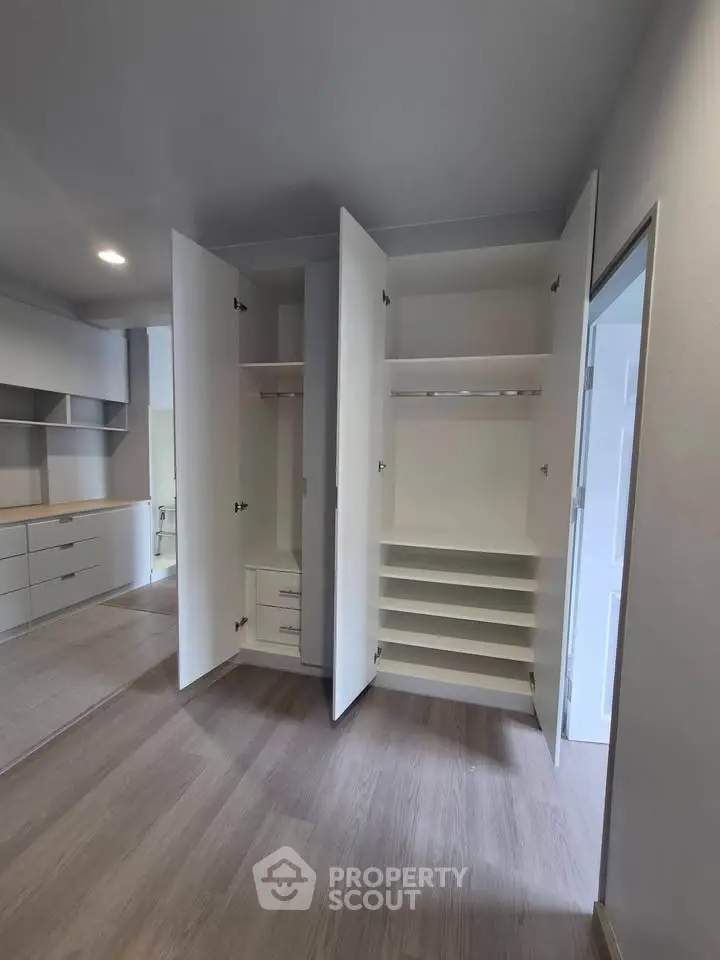 Spacious modern closet with ample storage in a stylish apartment interior.