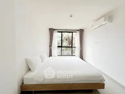 Spacious minimalist bedroom with large window and air conditioning in modern apartment.