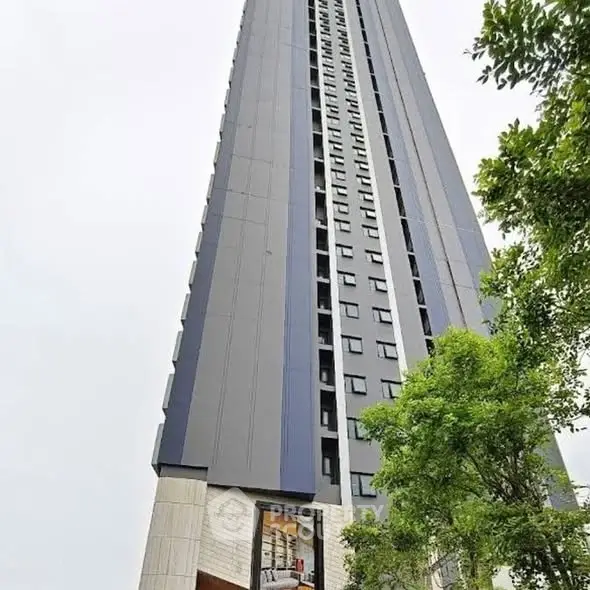 Stunning high-rise building with modern architecture and lush greenery.