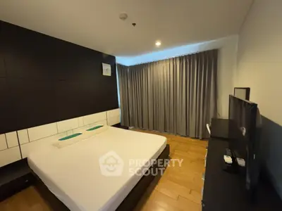 Modern bedroom with sleek design and large window curtains