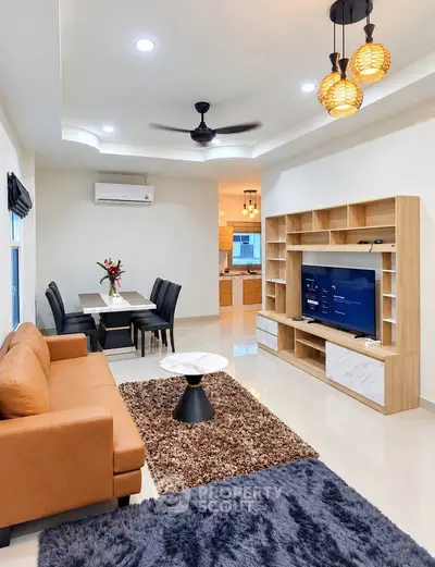 Modern living room with stylish furniture and open kitchen layout, perfect for contemporary living.