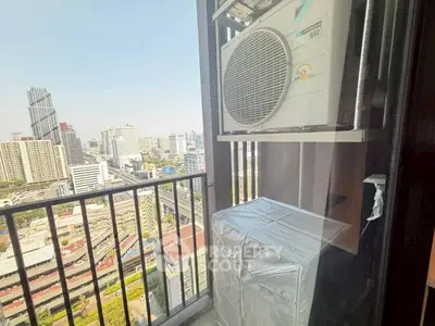 Stunning city view from a high-rise balcony with modern air conditioning unit.