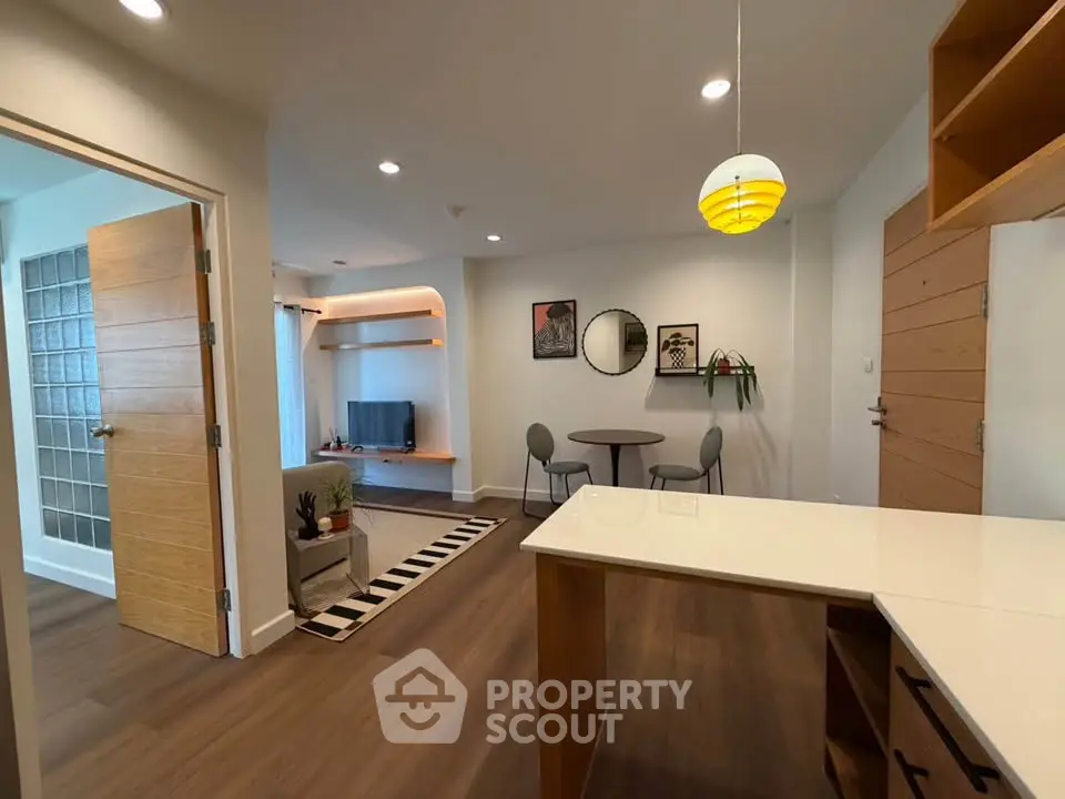 Modern open-plan living room with stylish decor and wooden flooring