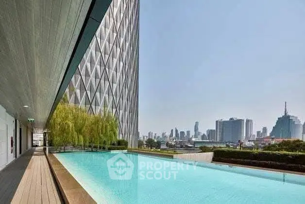 Luxurious rooftop pool with stunning city skyline view in modern high-rise building.