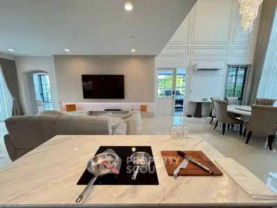 Luxurious open-plan living room with modern kitchen and elegant dining area