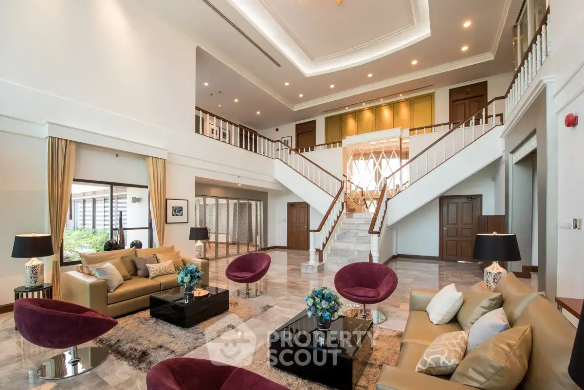 Luxurious spacious living room with high ceilings and elegant decor in a modern home.