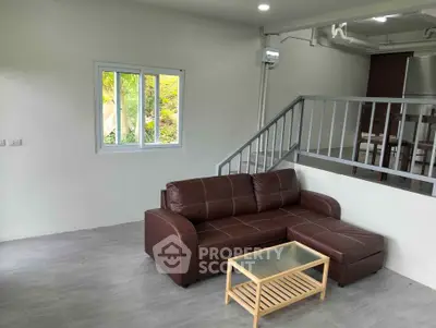 Modern living room with brown leather sofa and sleek design