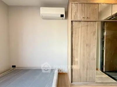 Modern bedroom with air conditioning and built-in wardrobe