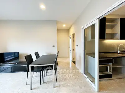 Modern open-layout living room with sleek dining area and stylish kitchen