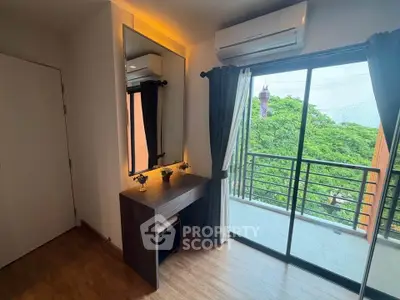 Chic bedroom with balcony view and modern vanity in urban apartment