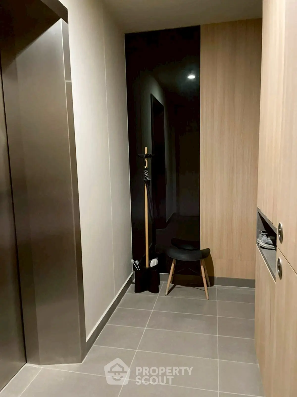 Modern apartment elevator lobby with sleek design and stylish seating area.