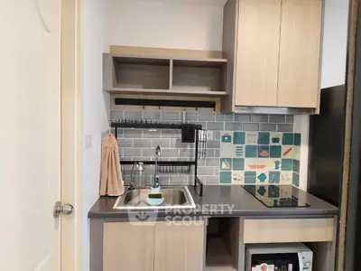 Modern compact kitchen with stylish backsplash and sleek cabinetry