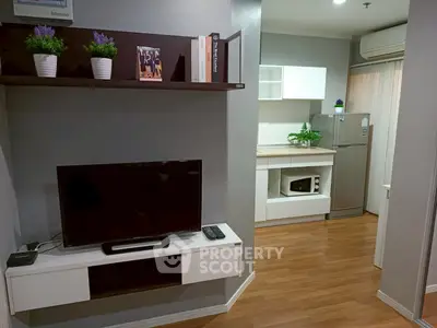 Modern apartment interior with stylish living room and kitchen, featuring wooden floors and sleek furniture.