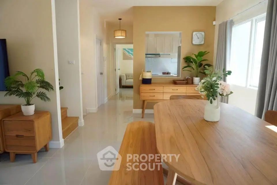 Modern dining area with wooden furniture and natural light