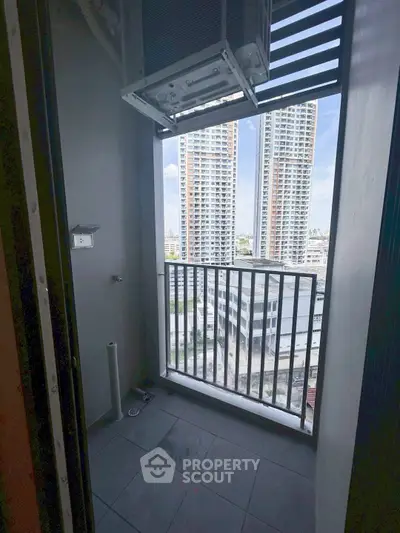 Compact balcony with city view in modern high-rise apartment