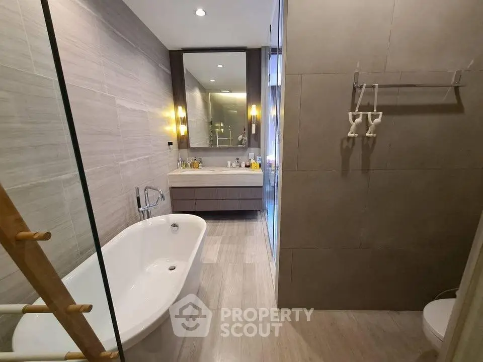 Luxurious modern bathroom with elegant bathtub and stylish vanity mirror.