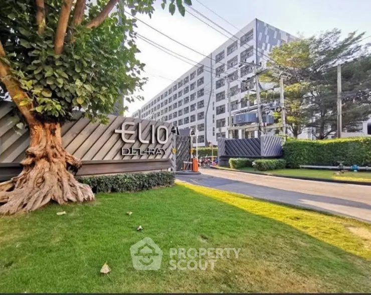 Modern residential building with lush green landscaping and contemporary design.