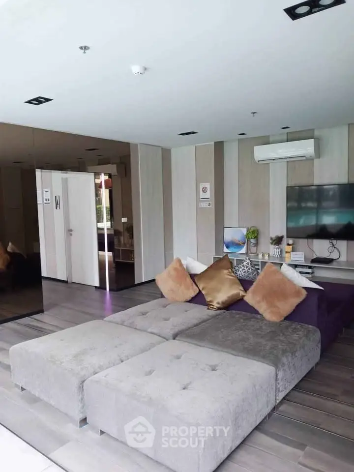 Modern living room with plush seating and stylish decor in a contemporary apartment.