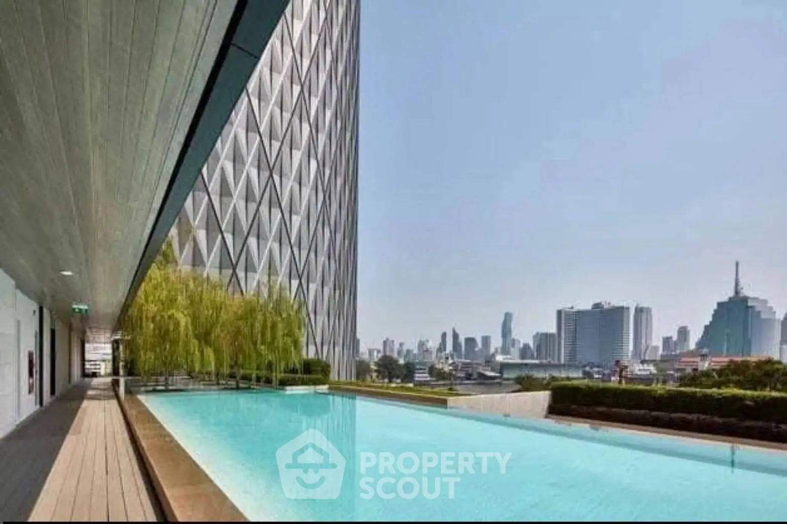 Luxurious rooftop pool with stunning city skyline views in modern high-rise building.